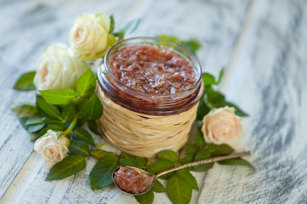 Pink jam with rose petalsRose petal jam in a glass jar on neutral grey kitchen table with copy space