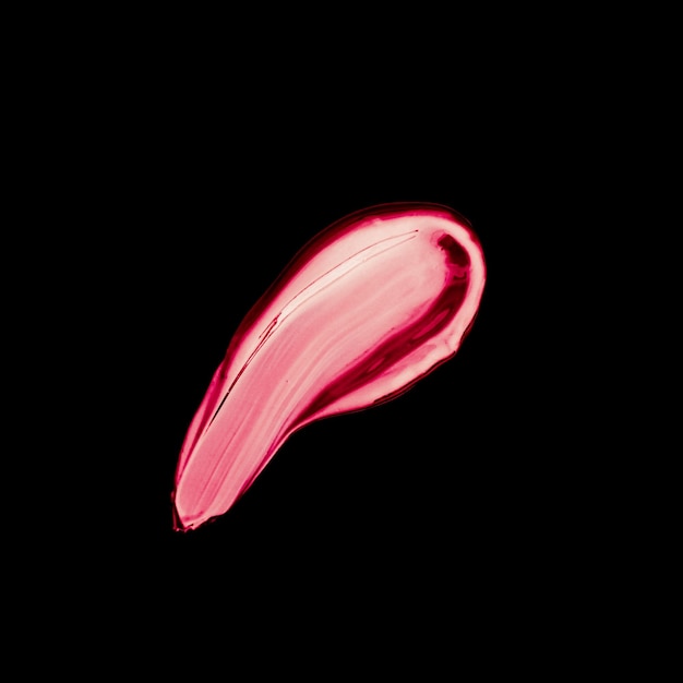 Pink lipstick brush stroke texture isolated on black background