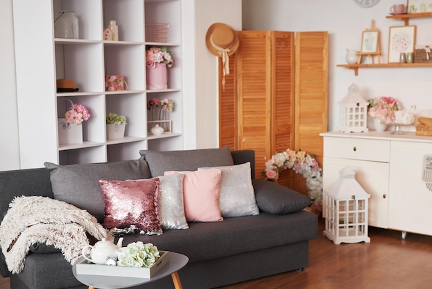 Pink living room. Studio apartment. Loft interior. Shelves and decor in room. Rent and delivery of housing. Hostel and hotel.