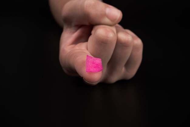 Pink lsd stamp mark on fingertip recreational drugs lysergic acid intake