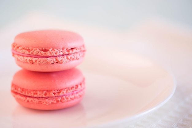 Pink macaroons on white tablecloth