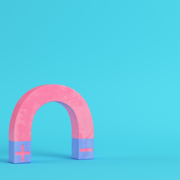 Pink magnet on bright blue background