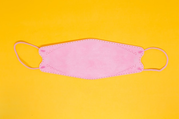 A Pink Mask in The Yellow Background with Landscape Posisiton