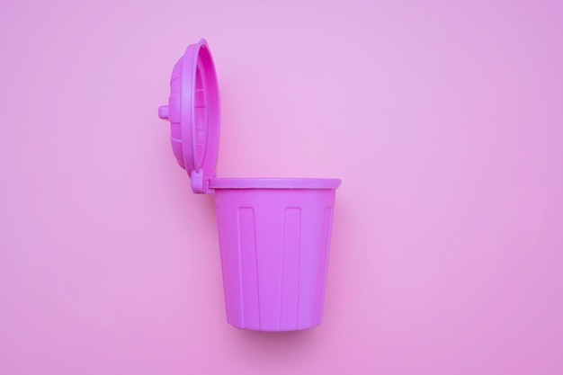 A pink mockup trash can with an open lid and it is open on a pink background