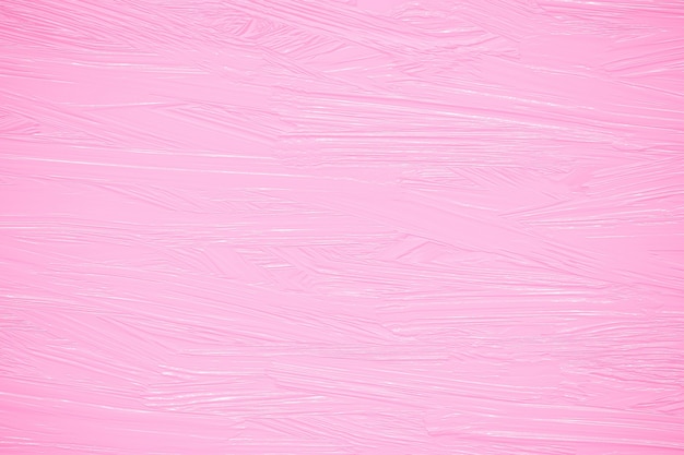 Pink oil paint on a wall, rough brush strokes on canvas