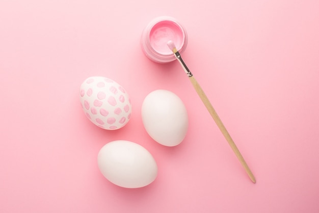 Pink painted easter eggs and paint brushes. Easter holiday concept.