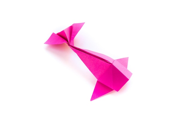 Pink paper fish origami isolated on a white background