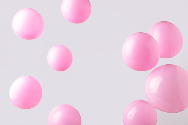 Pink pastel baloons on grey background. Minimalism. Top view