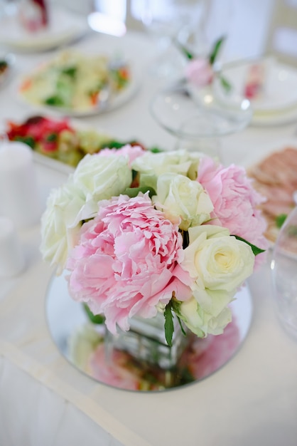 Pink peonies and roses in a wedding room