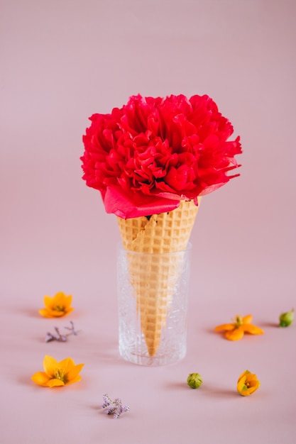 Pink peony in Ice Cream on pink with colorful flowers, copy space