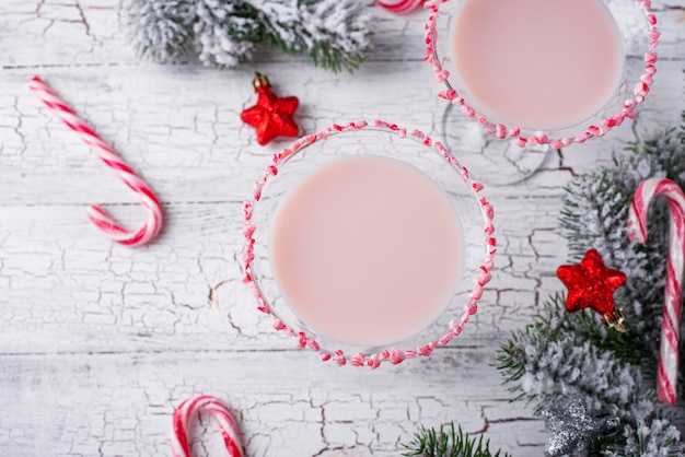 Pink peppermint martini with candy cane rim