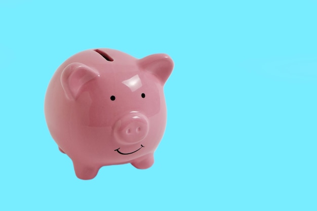 Pink Piggy Bank on Blue Background.