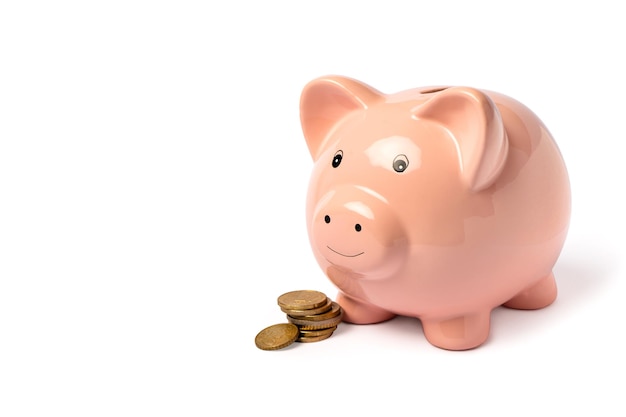 Pink piggy bank with coins beside isolated Save money financial planning of personal finances