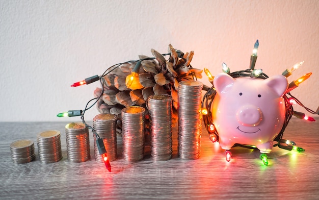 Pink piggy bank with coins pile growth graph and Party lights, Funly saving money for future investment plan and retirement fund concept.