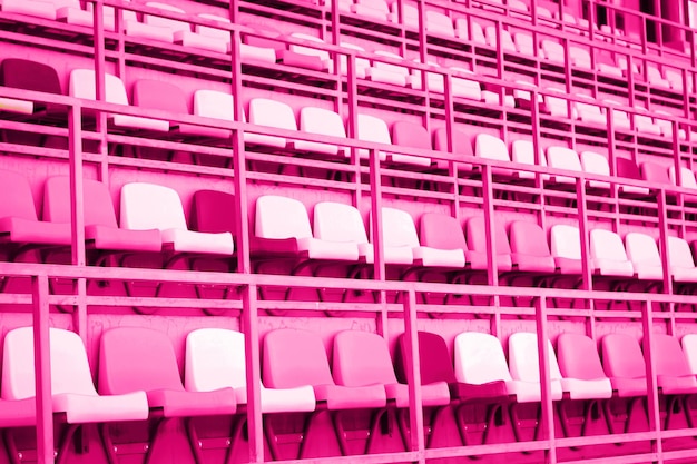 Pink plastic seats or chairs at stadium background