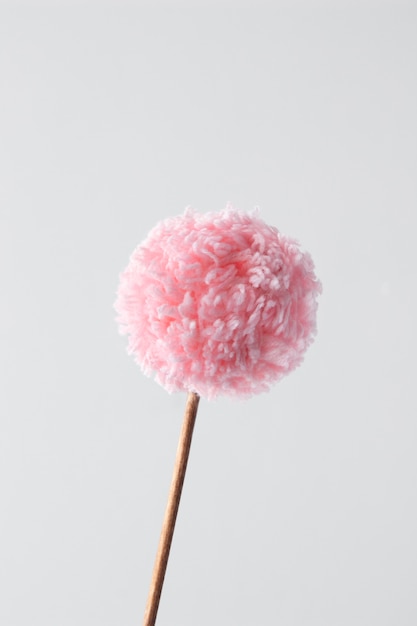 Pink pom pom with white background