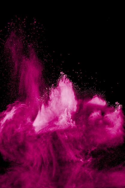 Pink powder explosion on black background.