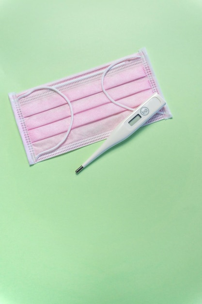 Pink protective mask with a thermometer