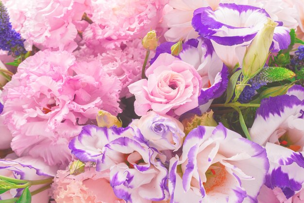 Pink and purple bouquet of flowers in a pink box isolated on white