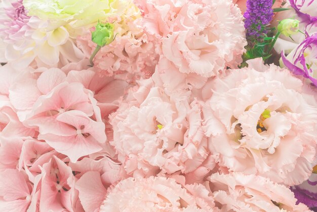 Pink and purple bouquet of flowers in a pink box isolated on white