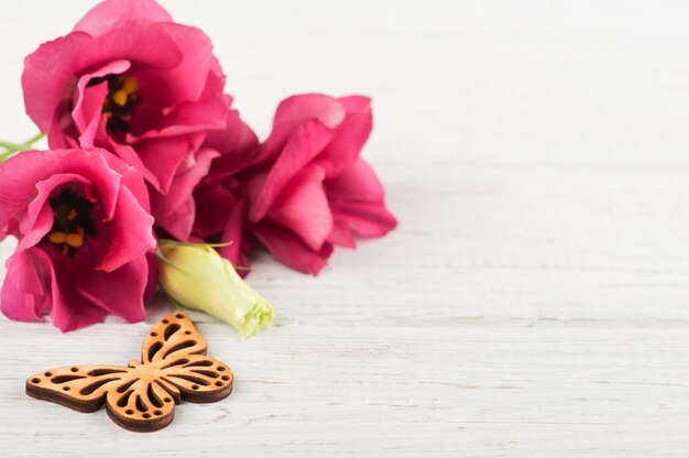 Pink purple eustoma flowers and wooden heart