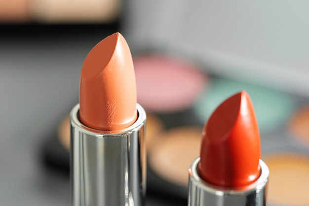 Pink and red lipsticks on vanity table