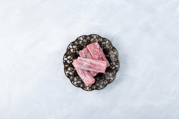 Pink red Marmalade with sweet sour taste rose and pomegranate on metal serving plate top view