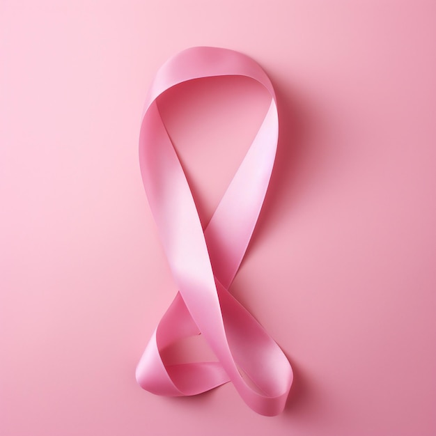 Pink ribbon on pink background Breast cancer awareness concept