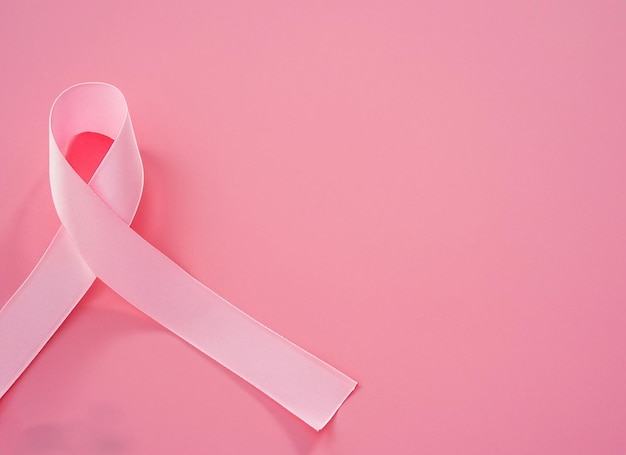 Pink ribbon on pink background