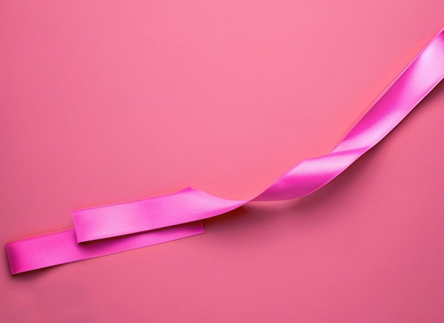 Pink ribbon on pink background