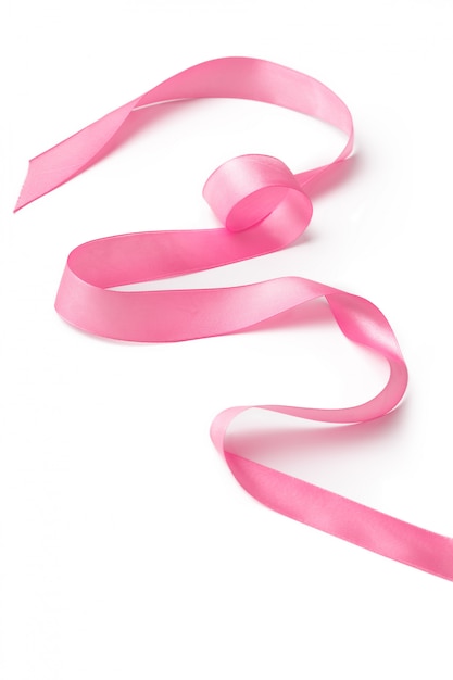 Pink ribbon on white surface