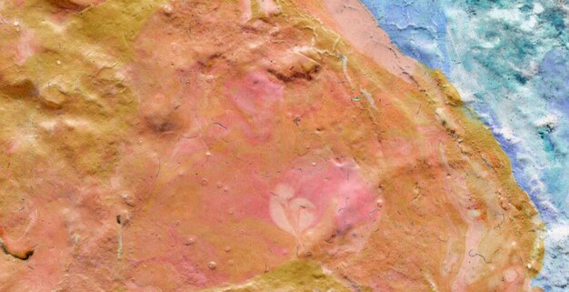 A pink rock with a blue background