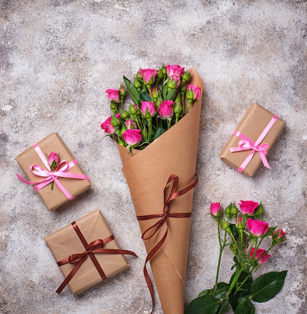 Pink roses bouquet  and gift boxes 