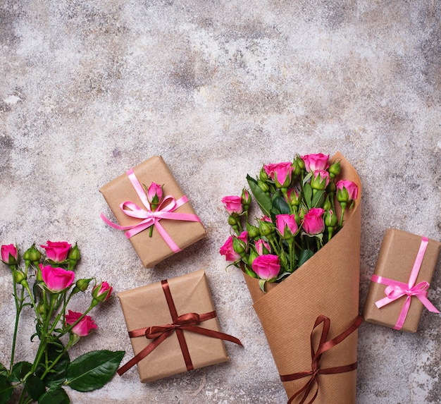 Pink roses bouquet  and gift boxes 