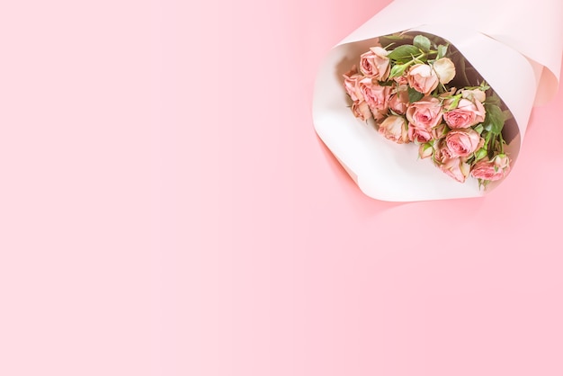 Pink roses bouquet on pink background