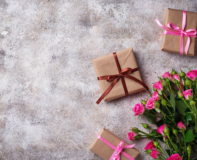 Pink roses and gift boxes with ribbons