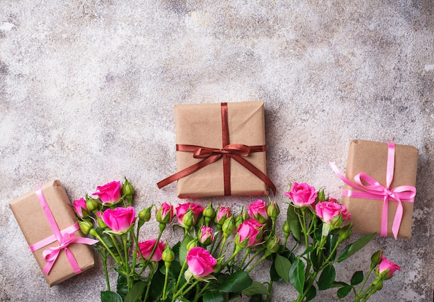 Pink roses and gift boxes with ribbons