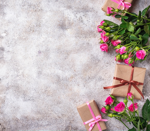 Pink roses and gift boxes with ribbons