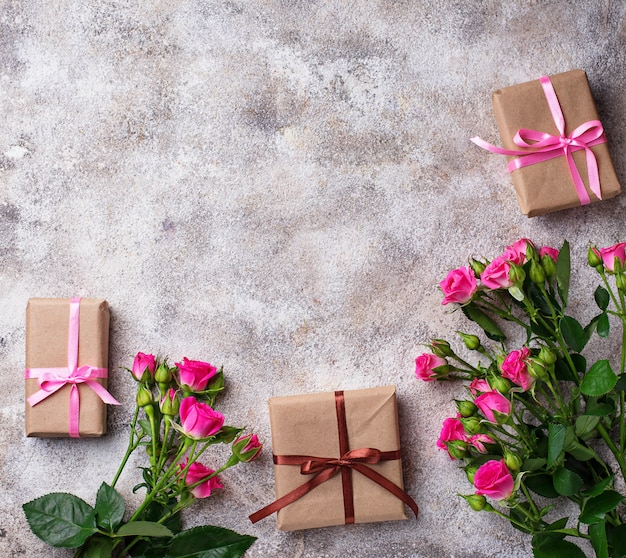 Pink roses and gift boxes with ribbons