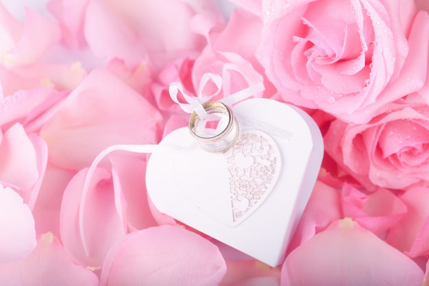 Pink roses and heart-shaped box wedding rings