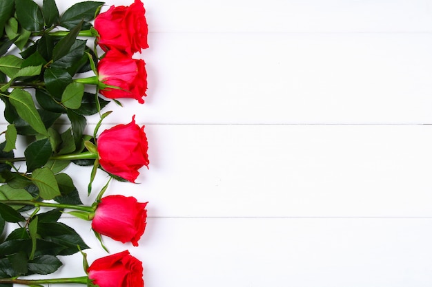 Pink roses on a white wooden table. Copy space Template for March 8, Mother's Day