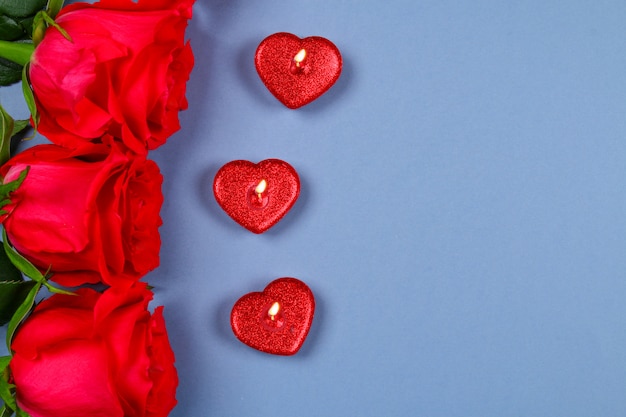 Pink roses with red candles in the shape of a heart. March 8, Mother's Day, Valentine's Day.