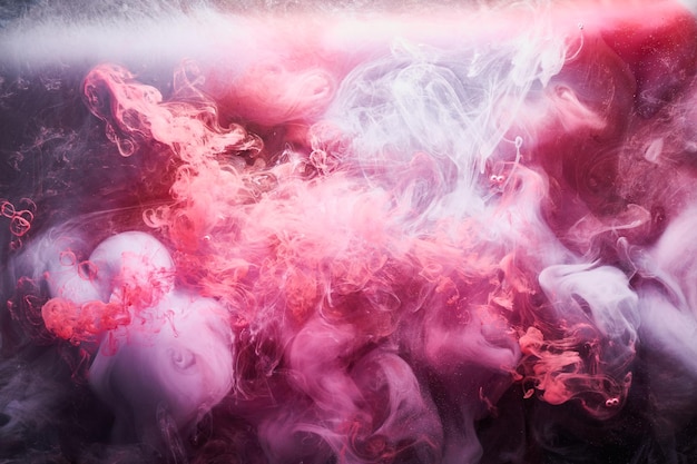 Pink smoke on black ink background, colorful fog, abstract swirling touch ocean sea, acrylic paint pigment underwater