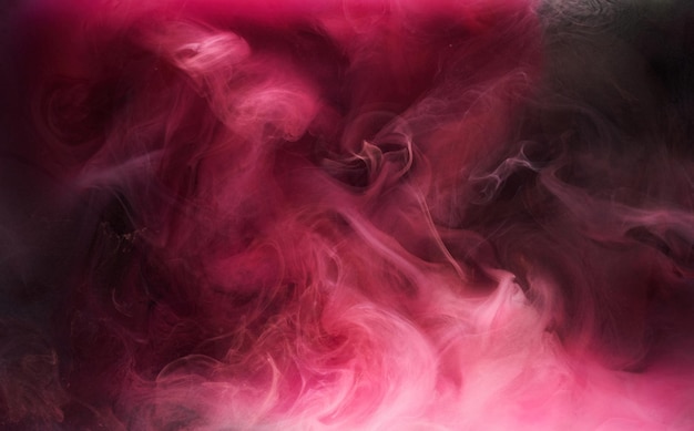 Pink smoke on black ink background, colorful fog, abstract swirling touch ocean sea, acrylic paint pigment underwater