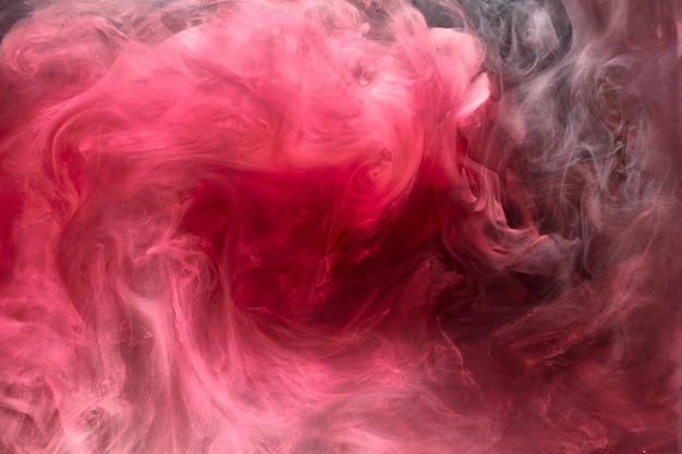 Pink smoke on black ink background, colorful fog, abstract swirling touch ocean sea, acrylic paint pigment underwater