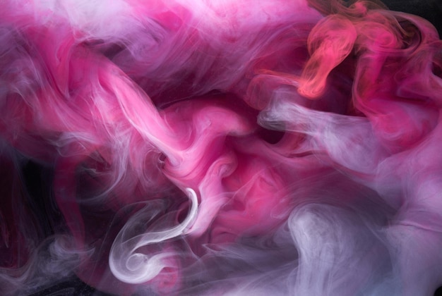 Pink smoke on black ink background, colorful fog, abstract swirling touch ocean sea, acrylic paint pigment underwater