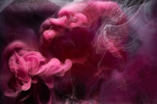 Pink smoke on black ink background, colorful fog, abstract swirling touch ocean sea, acrylic paint pigment underwater