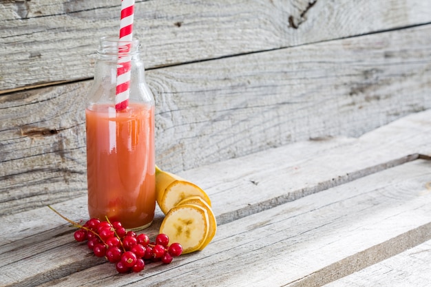 Pink smoothie on rustic wood  