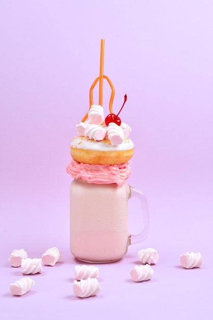 Pink strawberry freakshake with marshmallow and sweets