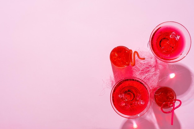 Pink summer cocktails on color background close up